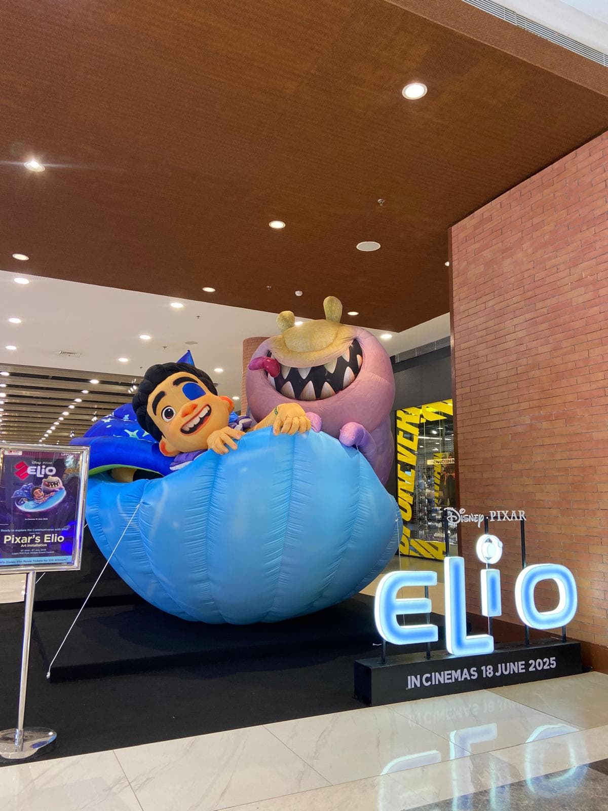 Giant inflatable of Elio and an alien character in a blue pod, built for Disney Indonesia and installed in a mall atrium