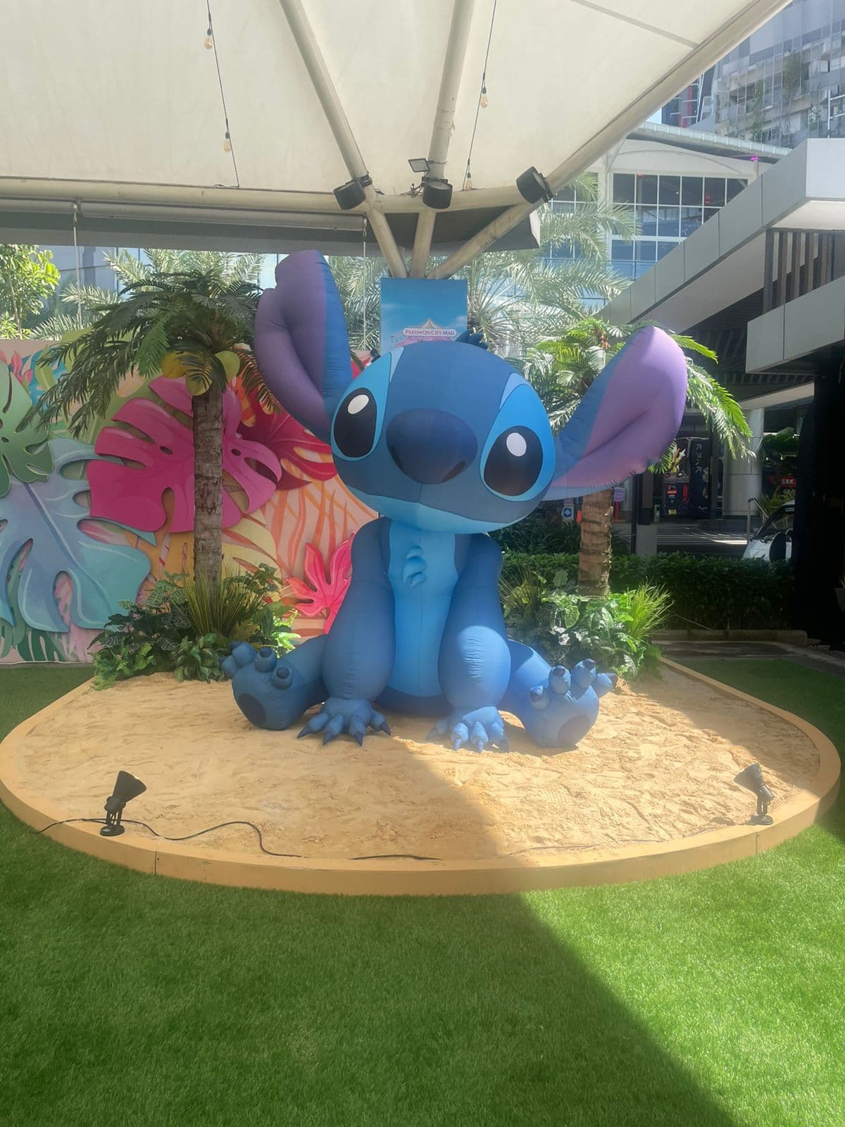 Large seated inflatable of Stitch on a sand display at Pakuwon City Mall, Indonesia
