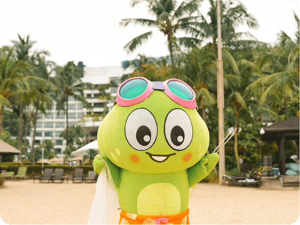 Green frog mascot costume at beach resort