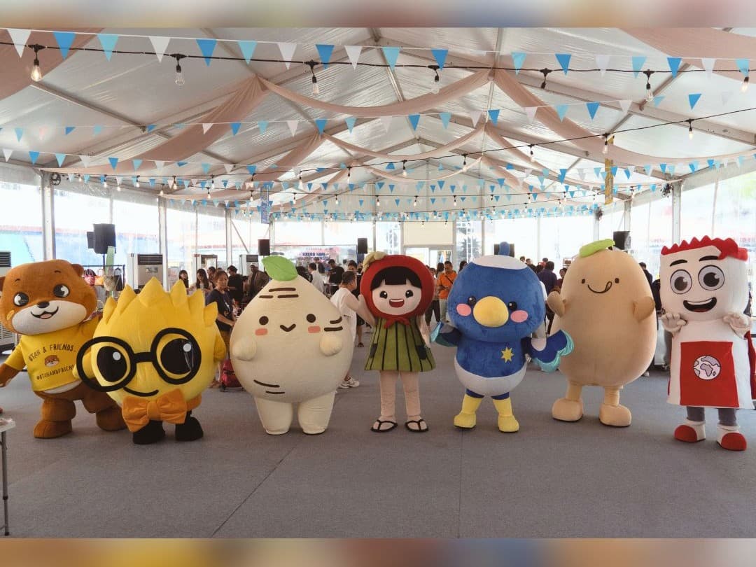 Mascots at a meet and greet in an event tent